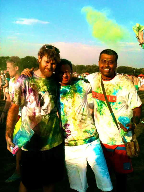 Lab members smiling covered in rainbow paint splatters