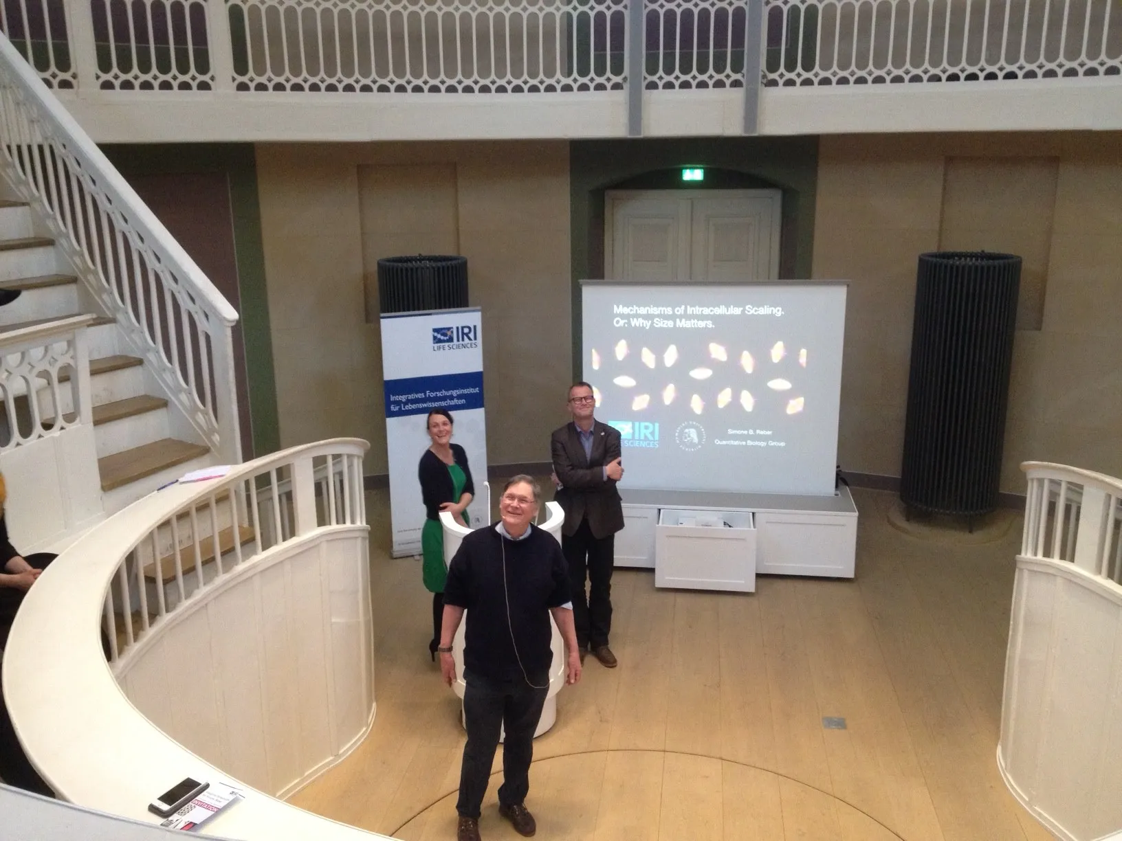 Tim Hunt (front) answers questions following his lecture. Simone Reber and Andreas Herrmann stand behind him.